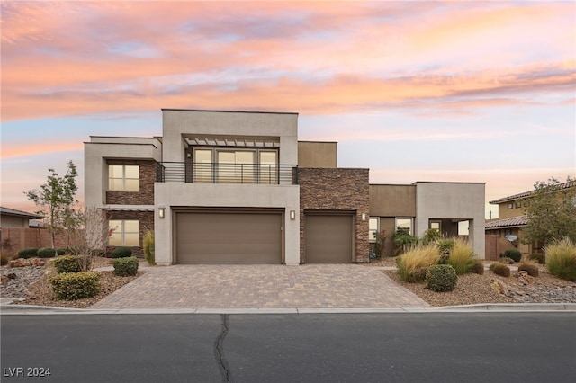 contemporary home with a balcony and a garage