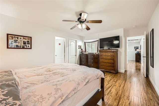 bedroom with hardwood / wood-style floors and ceiling fan