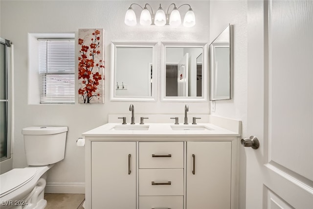 bathroom featuring tile patterned floors, vanity, and toilet