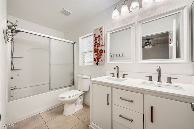 full bathroom featuring vanity, shower / bath combination with glass door, tile patterned floors, ceiling fan, and toilet