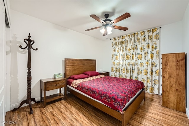 bedroom with hardwood / wood-style flooring and ceiling fan