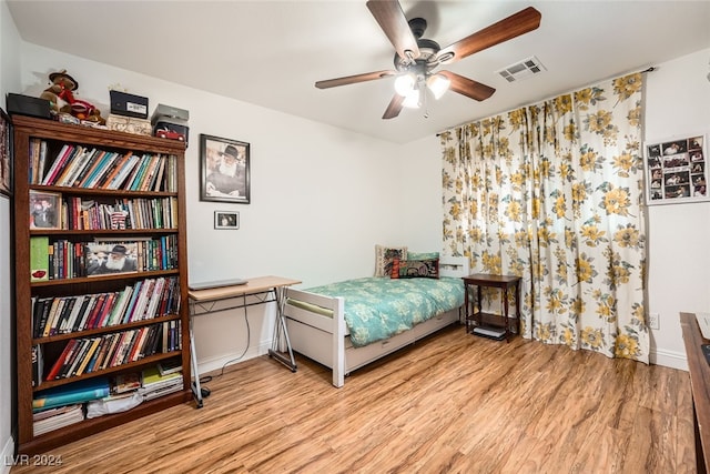 bedroom with ceiling fan and light hardwood / wood-style floors