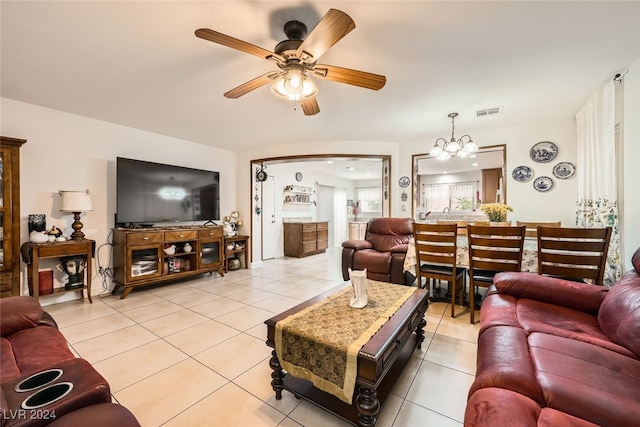 living room featuring light tile patterned flooring and ceiling fan with notable chandelier