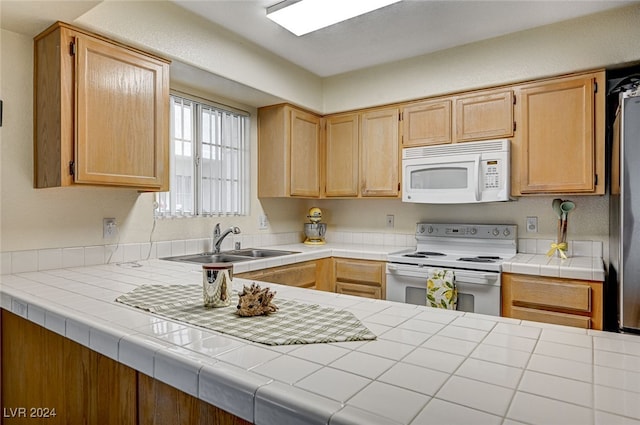 kitchen featuring tile counters, white appliances, sink, and light brown cabinetry