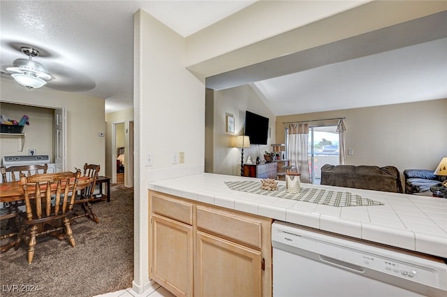 kitchen with carpet, light brown cabinetry, white appliances, and tile countertops