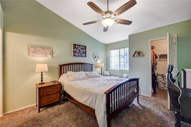 carpeted bedroom featuring ceiling fan, a closet, a walk in closet, and lofted ceiling