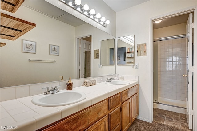 bathroom with vanity and a shower with shower door