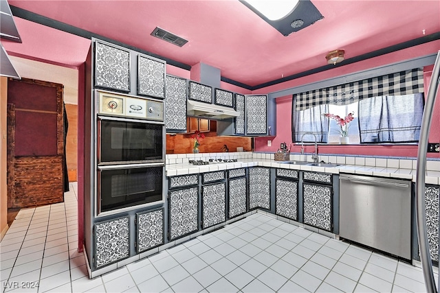 kitchen with tile countertops, dishwasher, sink, double oven, and extractor fan