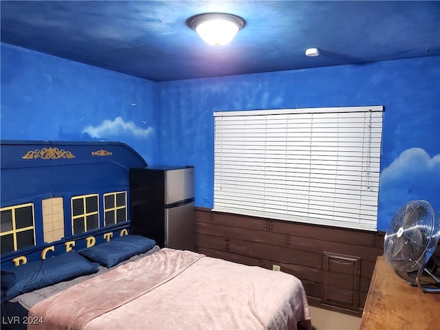 bedroom with stainless steel fridge