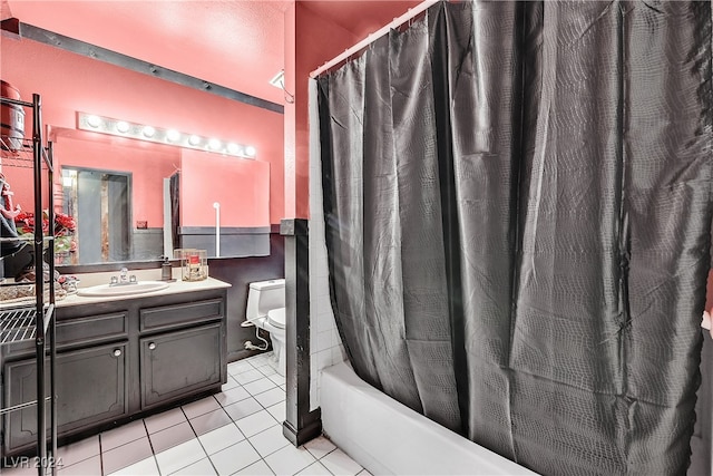 bathroom with toilet, vanity, and tile patterned floors