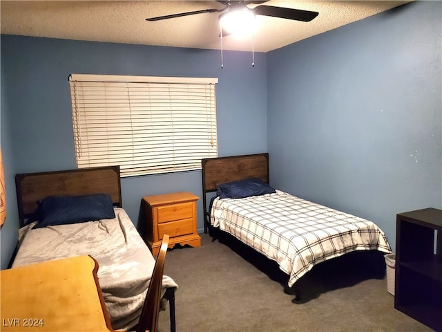 carpeted bedroom with ceiling fan and a textured ceiling