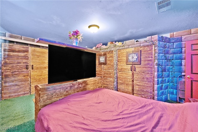 unfurnished bedroom featuring carpet and wooden walls