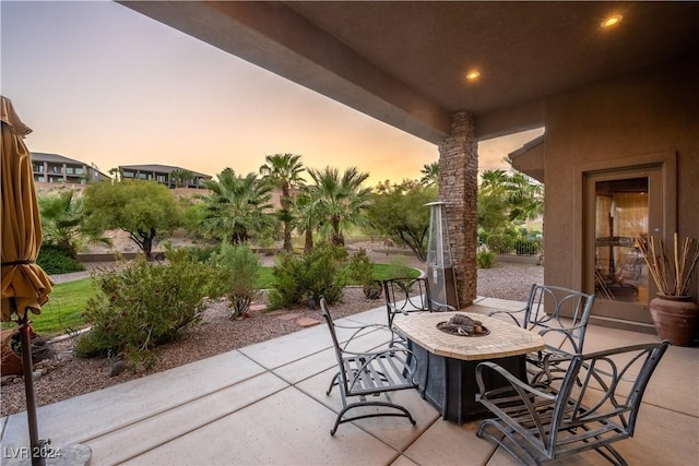 patio terrace at dusk with an outdoor fire pit