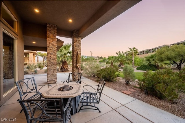 patio terrace at dusk with a fire pit