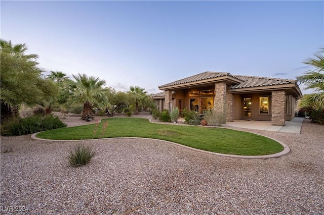 rear view of property featuring a yard