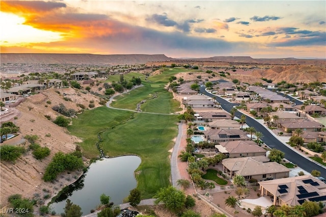 aerial view at dusk with a water and mountain view