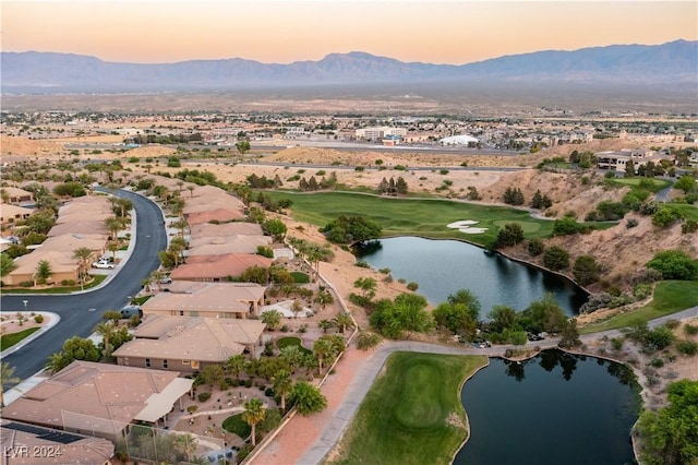 aerial view at dusk with a water and mountain view