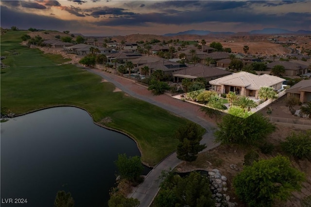 aerial view at dusk with a water view