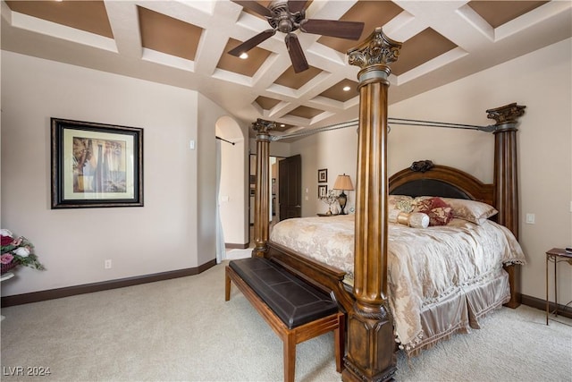 carpeted bedroom featuring ceiling fan, coffered ceiling, beam ceiling, and ornate columns