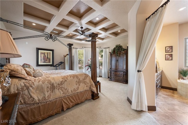 bedroom featuring coffered ceiling, ceiling fan, beamed ceiling, light colored carpet, and decorative columns