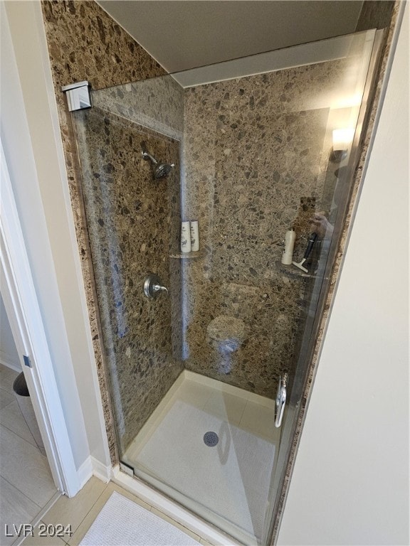 bathroom with tile patterned floors and walk in shower