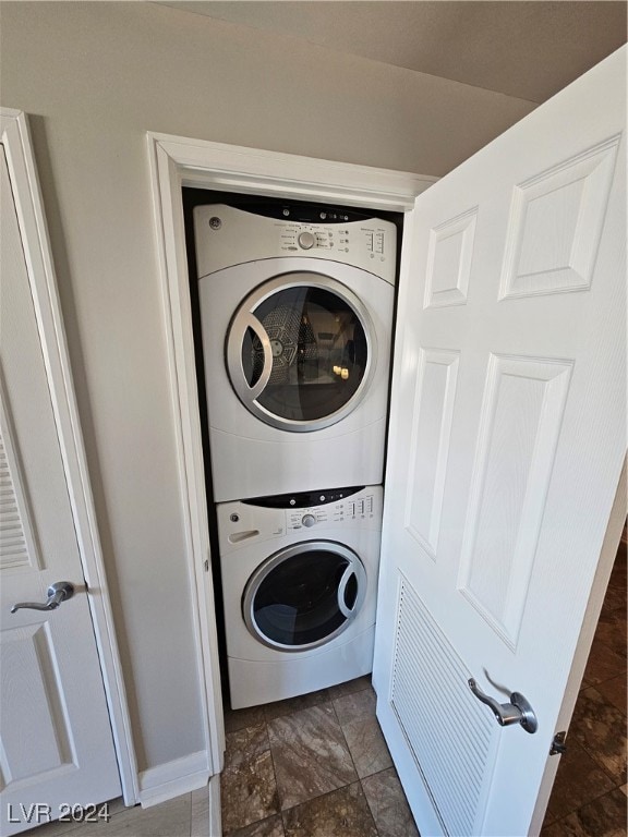 clothes washing area with stacked washer / drying machine