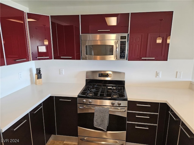 kitchen with stainless steel appliances and hanging light fixtures