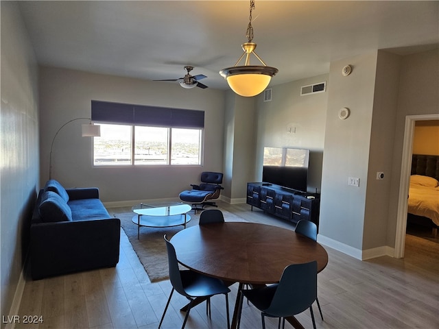 living room with ceiling fan and light wood-type flooring