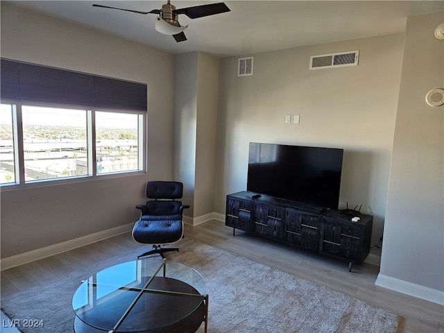 living room featuring light hardwood / wood-style floors and ceiling fan