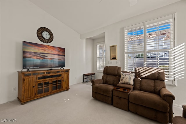 carpeted living room with vaulted ceiling