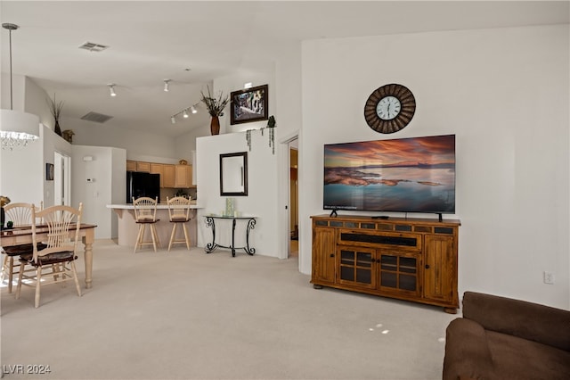 carpeted living room with vaulted ceiling