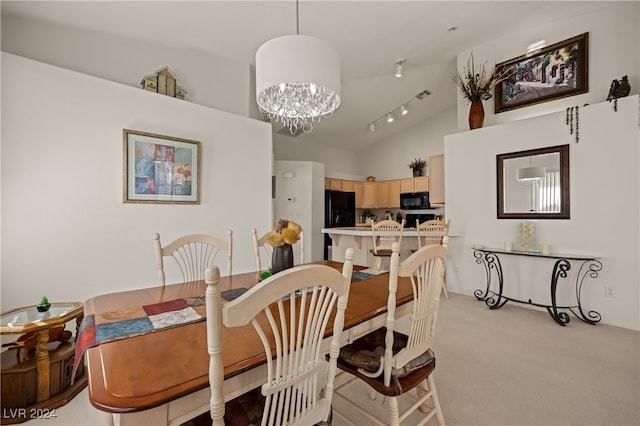 dining area with track lighting, light carpet, high vaulted ceiling, and a chandelier