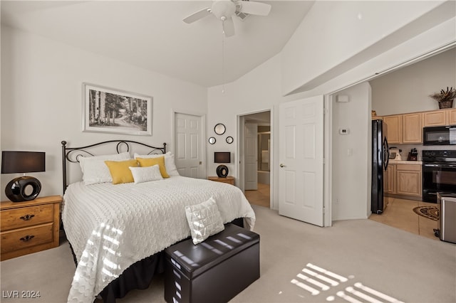 bedroom featuring ensuite bathroom, black fridge, light colored carpet, ceiling fan, and high vaulted ceiling