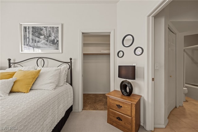 carpeted bedroom with a spacious closet