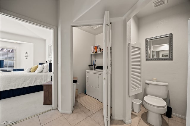 bathroom with tile patterned floors, separate washer and dryer, and toilet