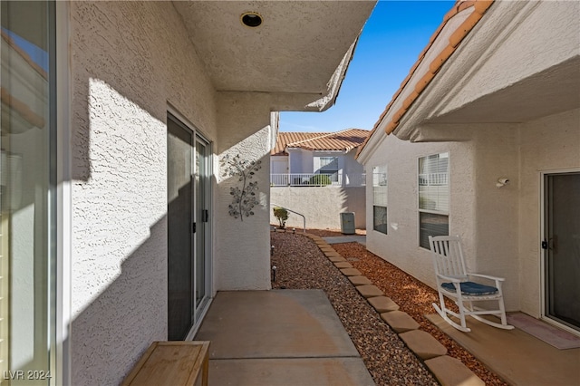 view of side of property with a patio area