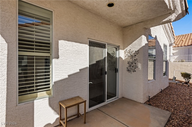 entrance to property featuring a patio