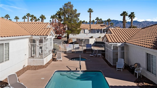 view of swimming pool with a mountain view and a patio