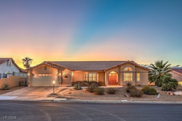 mediterranean / spanish-style home with a garage