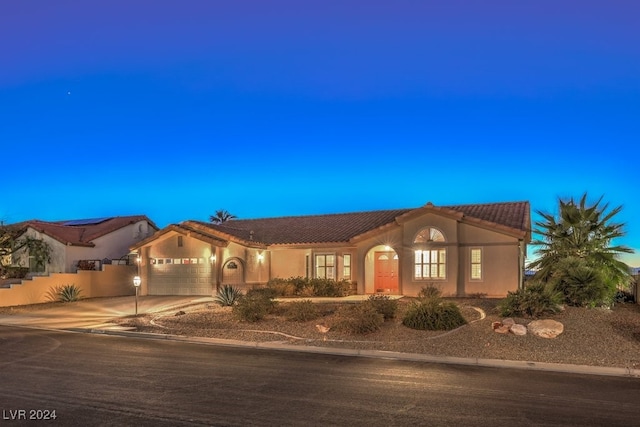 mediterranean / spanish-style house featuring a garage