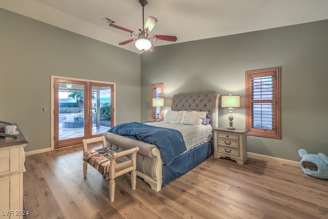 bedroom featuring ceiling fan, high vaulted ceiling, light hardwood / wood-style flooring, and access to outside