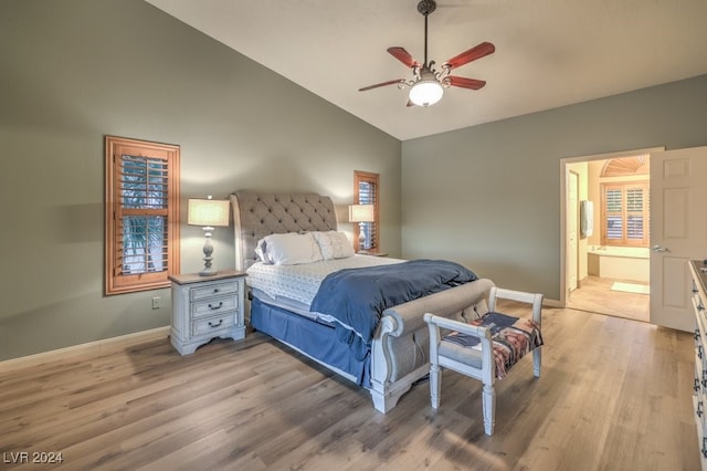 bedroom with lofted ceiling, light hardwood / wood-style flooring, ceiling fan, and ensuite bathroom