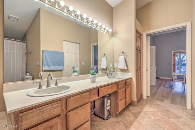 bathroom with vanity, tile patterned flooring, and toilet