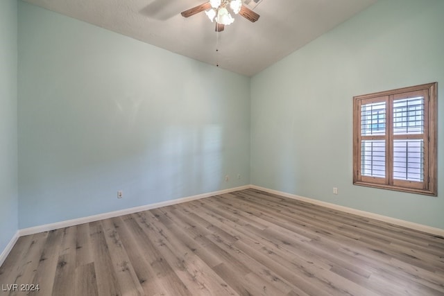 spare room with ceiling fan, lofted ceiling, and light hardwood / wood-style floors