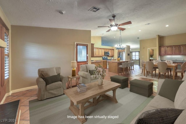 tiled living room with lofted ceiling, a textured ceiling, and ceiling fan