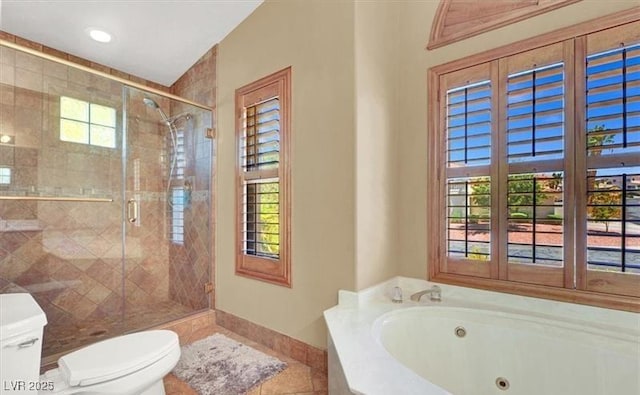 bathroom featuring independent shower and bath, tile patterned flooring, and toilet