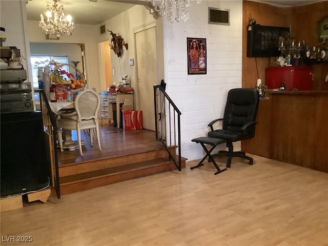 interior space featuring an inviting chandelier and hardwood / wood-style floors