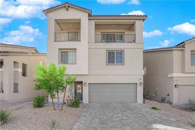 view of front of home featuring a balcony and a garage