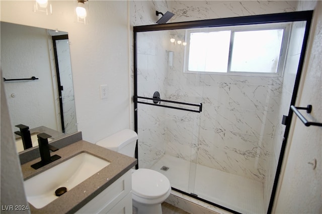 bathroom featuring vanity, toilet, and walk in shower