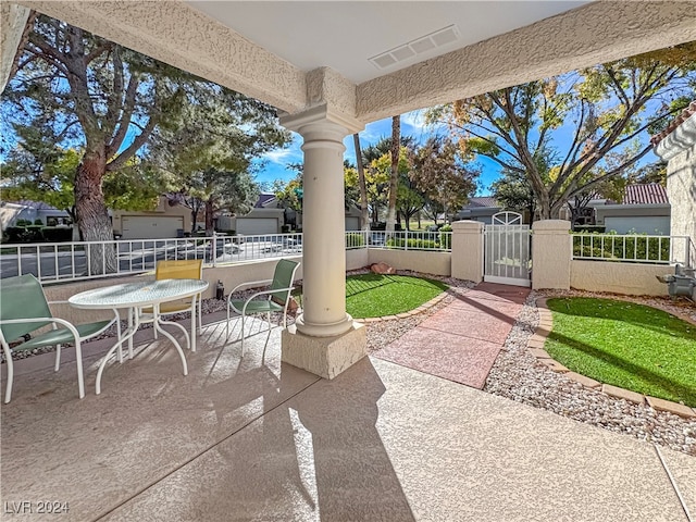 view of patio / terrace with visible vents, fence, and a gate